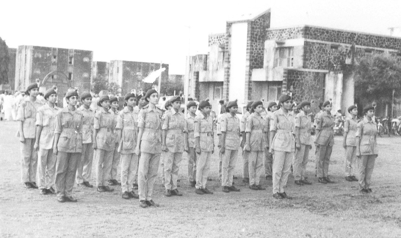 Girls NCC cadets in an archival campus formation near the 1970s academic expansion period